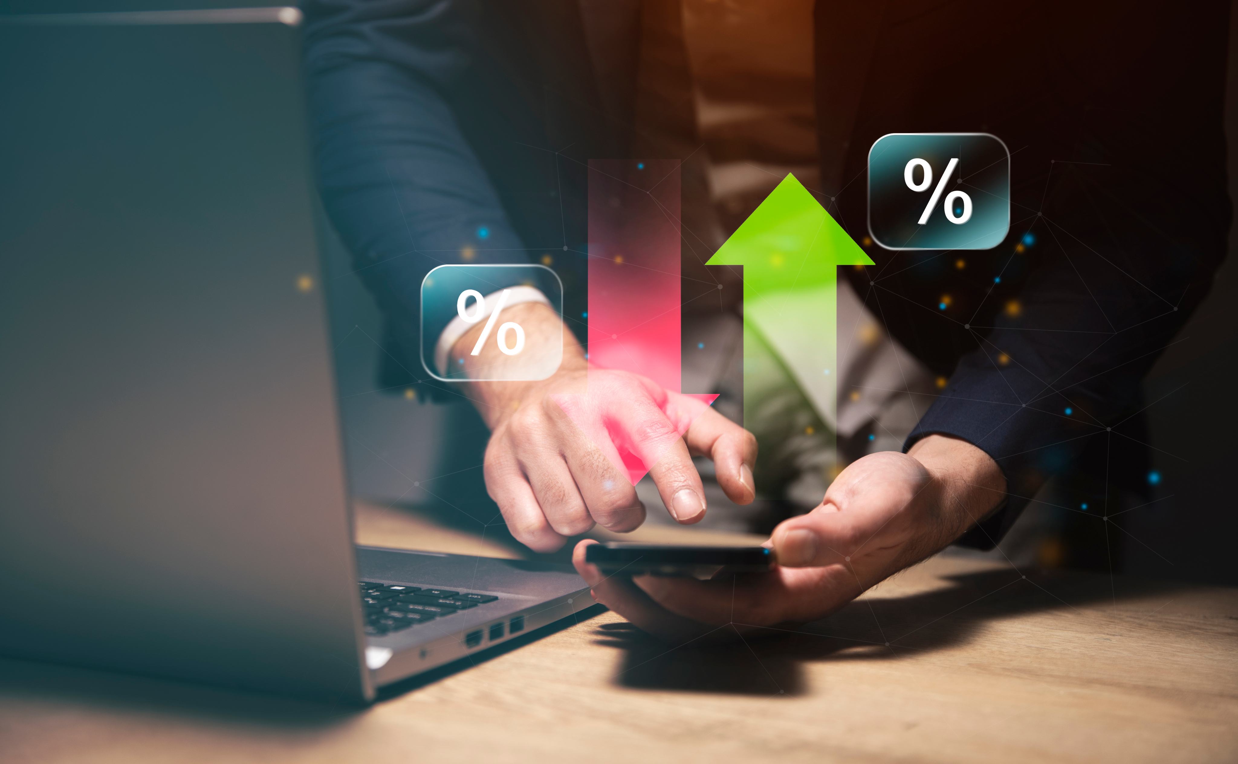 Hands on a laptop with red and green percentage arrows showing conversion rate metrics