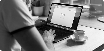 Person working on laptop with Google search