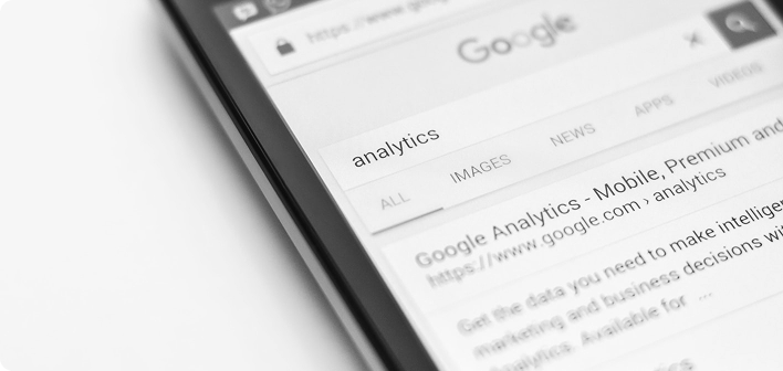 Hand holding smartphone showing Google search