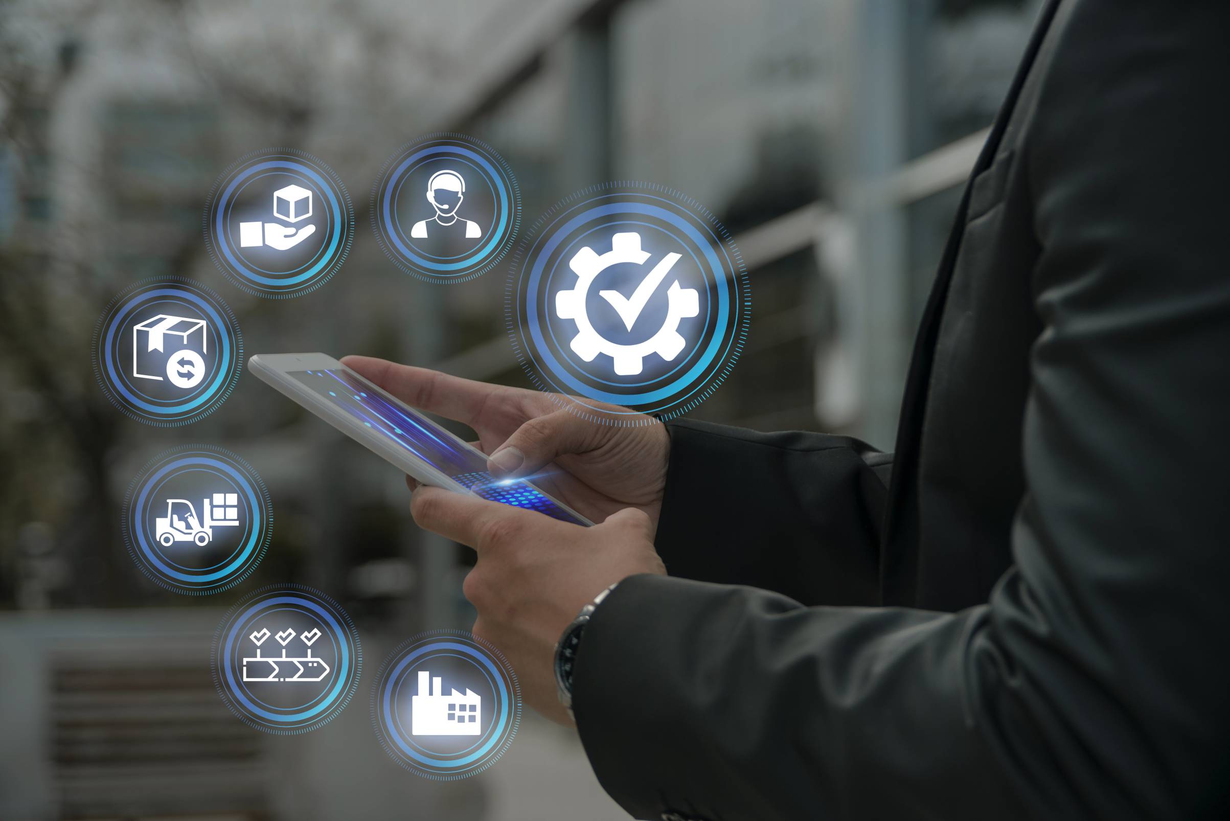 Businessman holding a tablet with quality control process icons