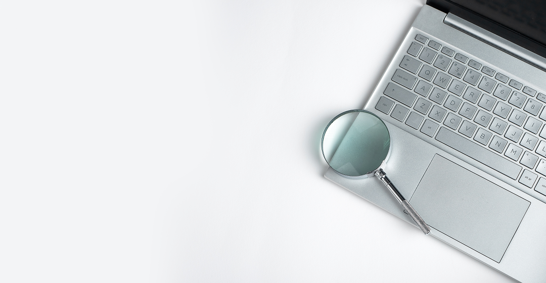 Local SEO services - laptop keyboard with magnifying glass