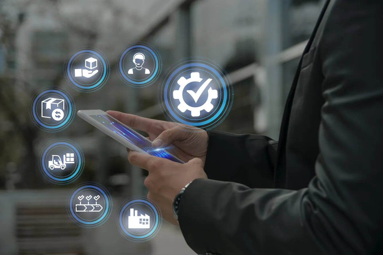 Businessman holding a tablet with quality control process icons